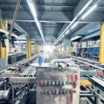 Vanway Tech aluminum extrusion profiles moving on the conveyor belt in the factory production line, showing the automated manufacturing process of industrial-grade aluminum alloy profiles before surface treatment
